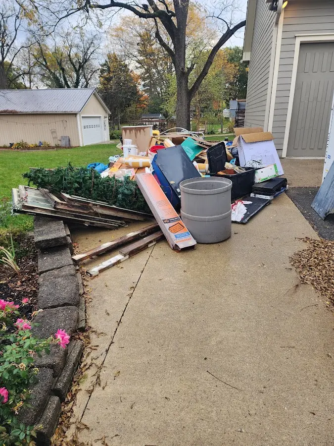 Dumpster being loaded with debris for 12 Yard Dumpster Rental in Cody